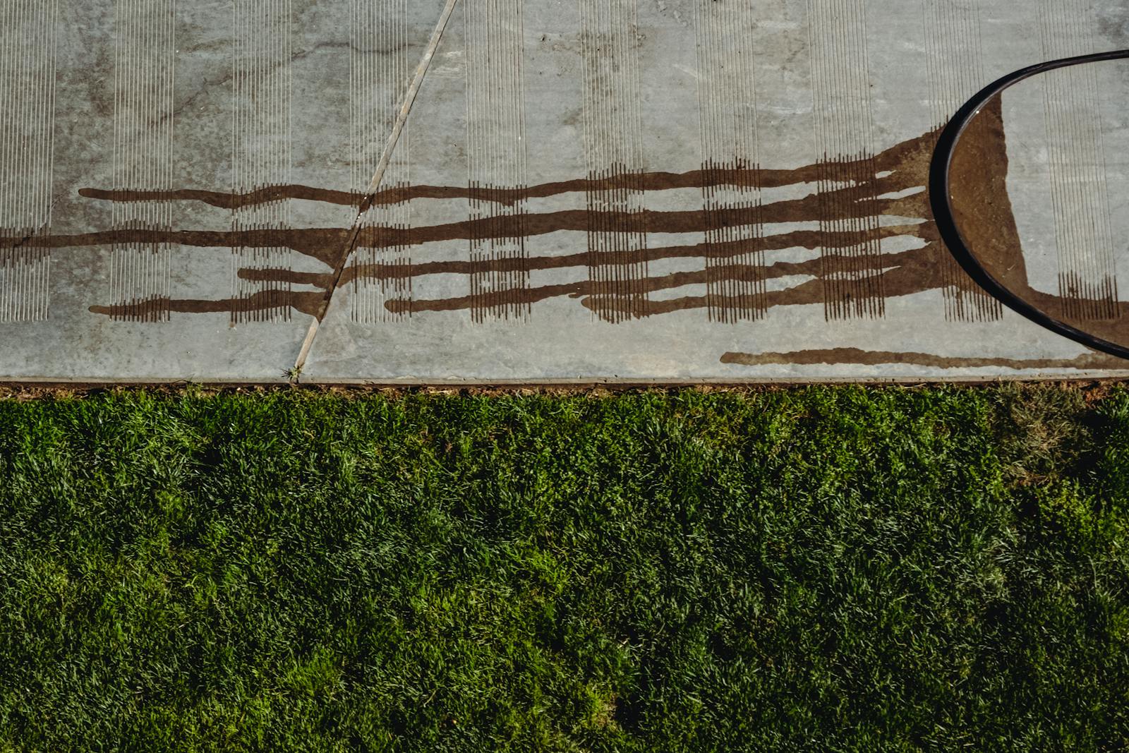 Close-up of dark streaks and stains on a Bethesda concrete driveway